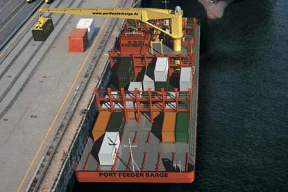 A key element of the barge is that it’s equipped with its own full scale container crane.