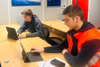 Two Peel Ports apprentices working on computers