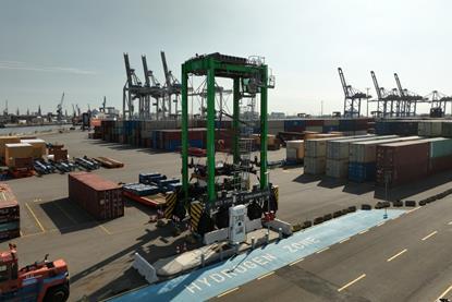 The hydrogen straddle carrier pictured on the quayside at Container Terminal Tollerort