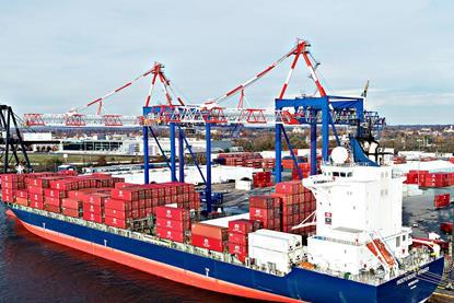 Cargo ship at dock with containers about to be unloaded by Liebherr STS cranes 