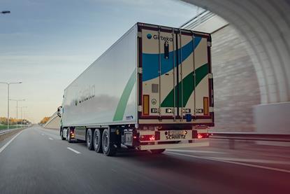 The image shows a Girteka cargo truck on the road
