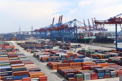 The image shows containers on a quayside in Germany