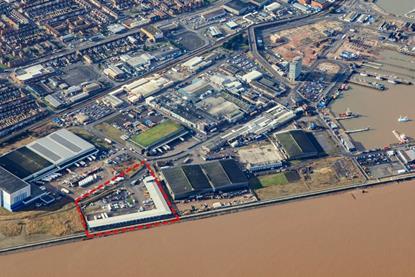 An aerial shot of the Port of Grimsby showing the Grimsby Seafood Village outlined in red in the bottom left
