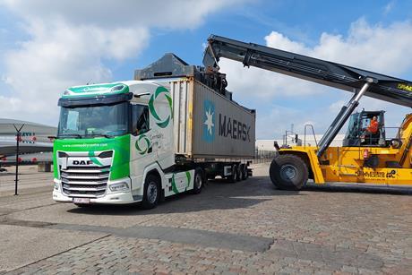 Truck with Maersk container being lifted off by a forklift