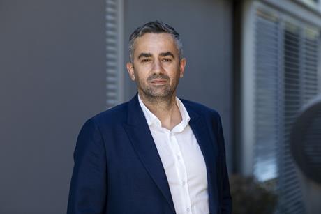 A picture of Phillipos Ioulianou dressed in a blue suit smiling for the camera