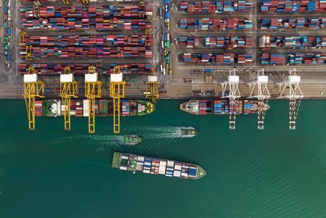 Cargo ship and truck at seaport waiting for container dock by crane shipment
