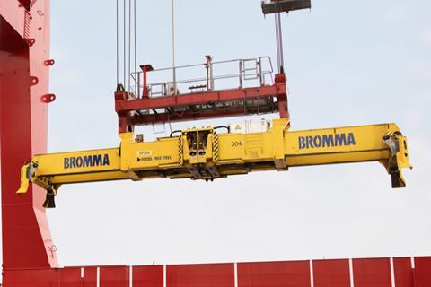 The image shows a Bromma spreader in action on the quayside