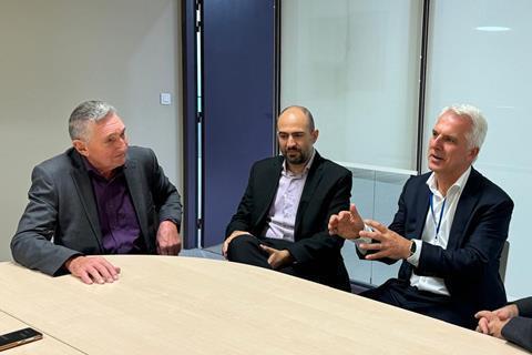 The image shows the GPC 2025 chairs in discussion round a table