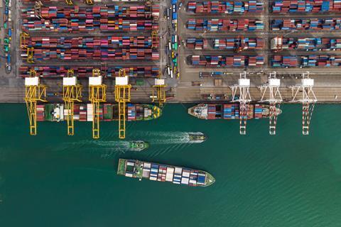 Cargo ship and truck at seaport waiting for container dock by crane shipment