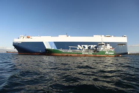 The picture shows NYK Line’s Atlas Leader being bunkered with biofuels by Cepsa’s electric port hybrid barge, Bahía Levante